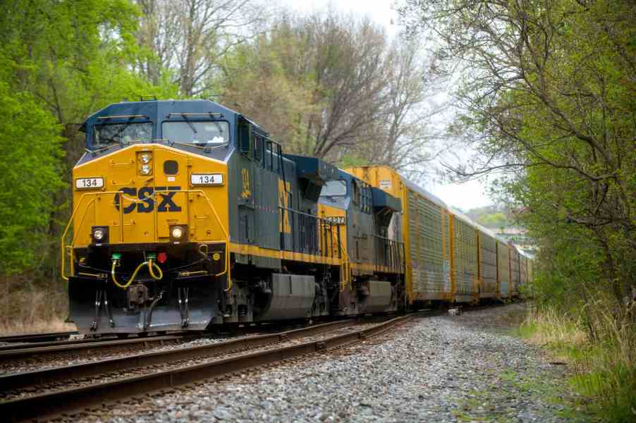A CSX train on tracks in left front angle view