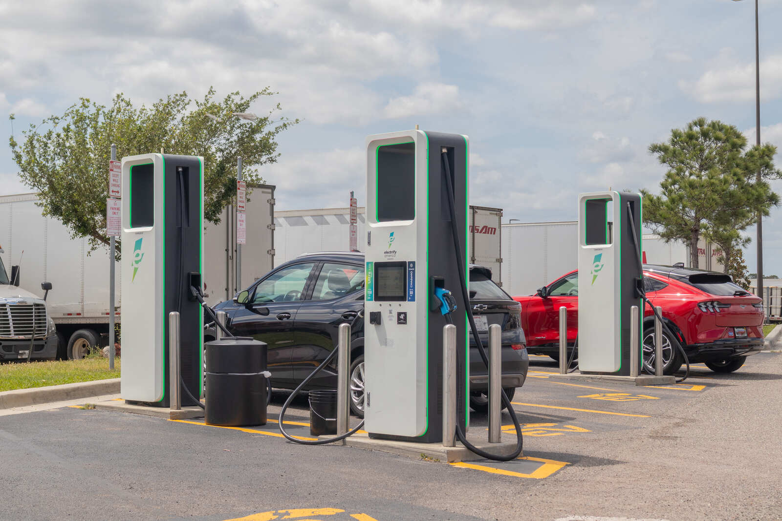 An EV charging station with electric cars plugged in
