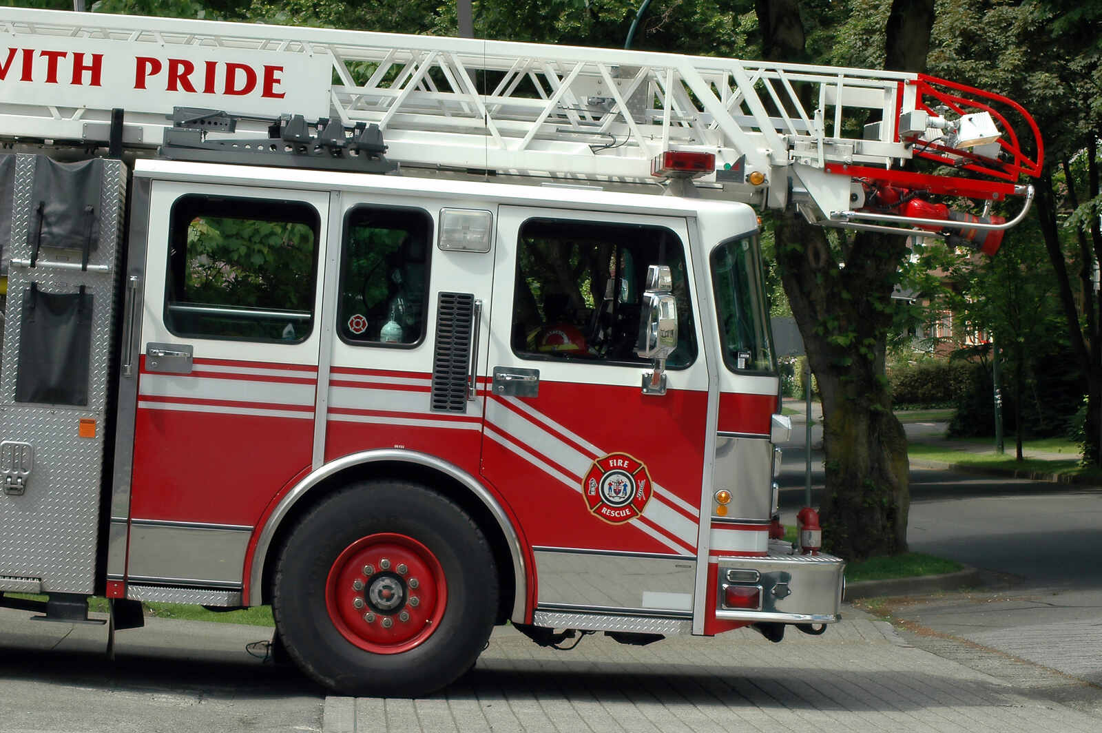 A fire department ladder truck in close view of right cab