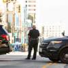An LAPD officer holds a roadblock after a an armored vehicle rammed a stolen truck to stop a police chase.