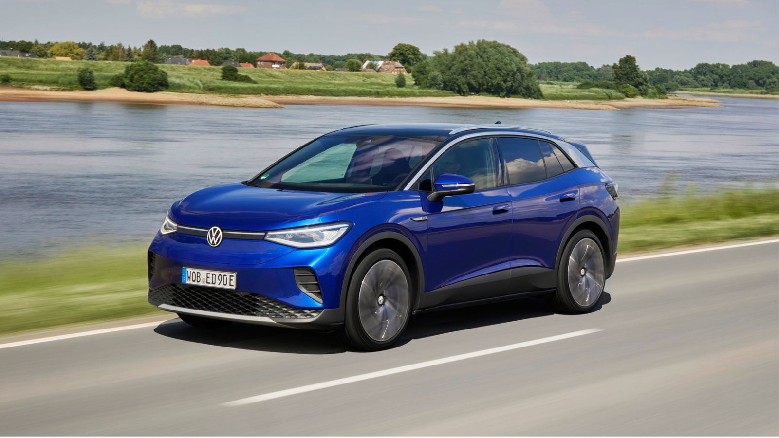 A blue VW ID.4 EV driving in left front angle view