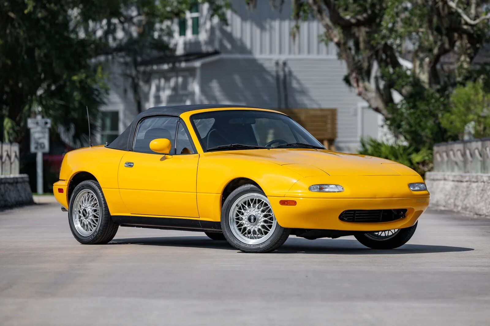 A yellow 1992 Mazda MX-5 Miata parked in right front angle view