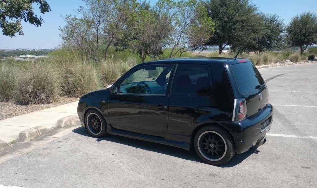 1999 Volkswagen Lupo hot hatch silhouette, trees visible in the background.