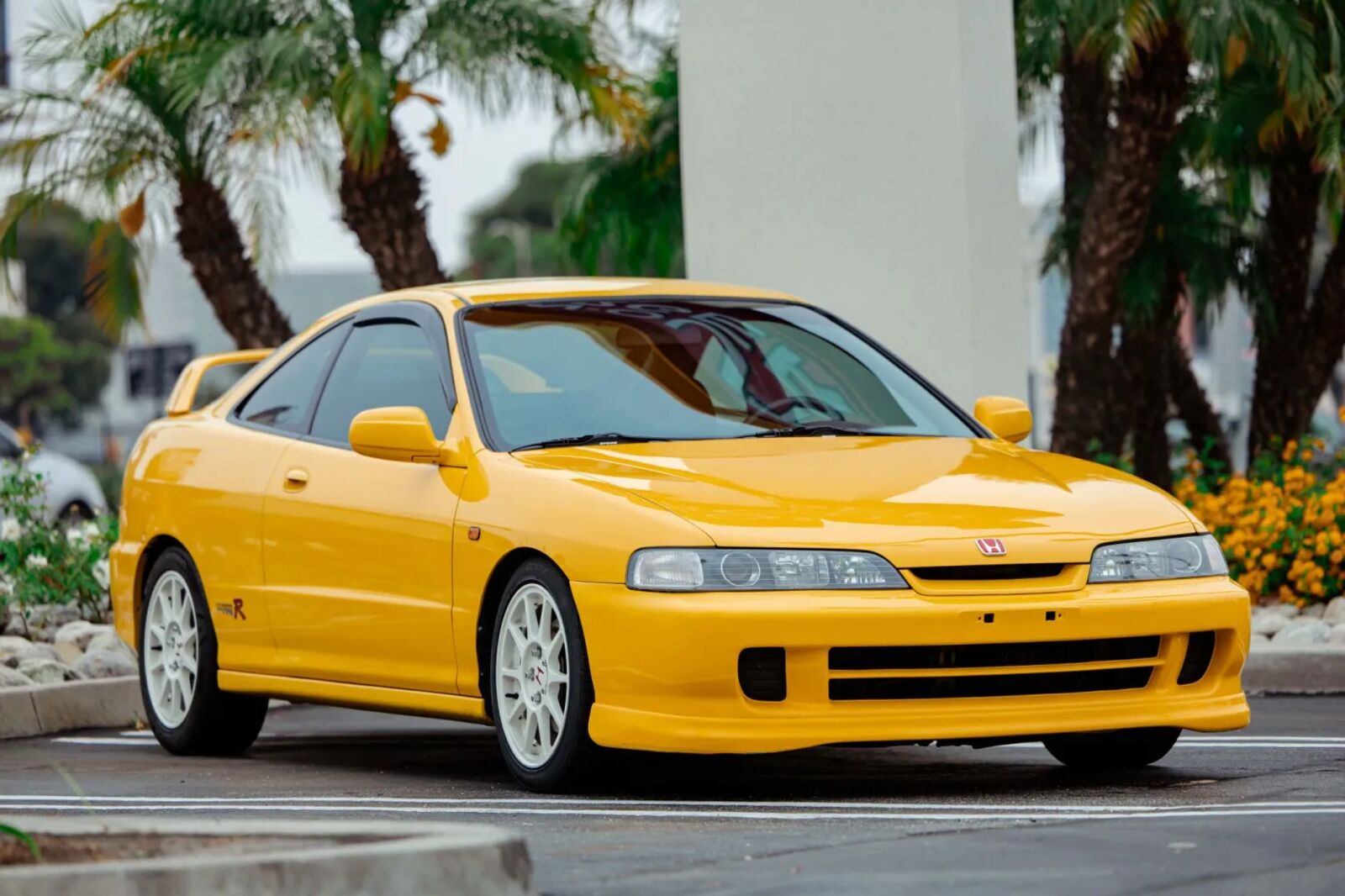 A yellow 2000 Acura Integra Type R parked in right front angle view