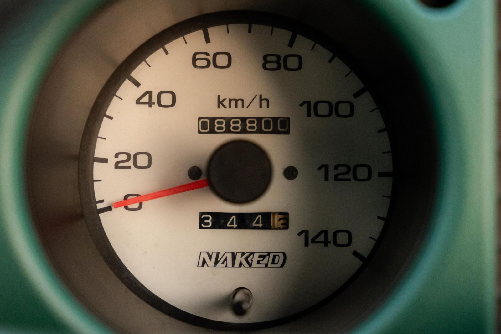 Speedometer in the green dashboard of a Daihatsu Naked