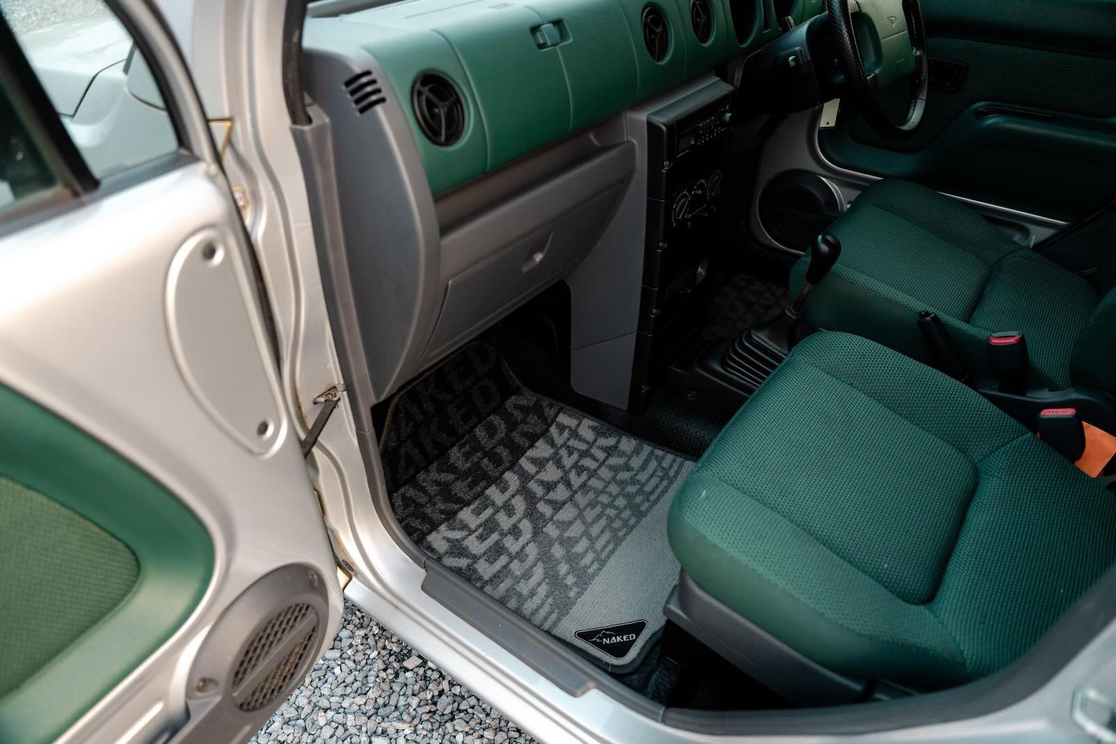 Green interior and "Naked" floor mats in a Daihatsue Kei-car