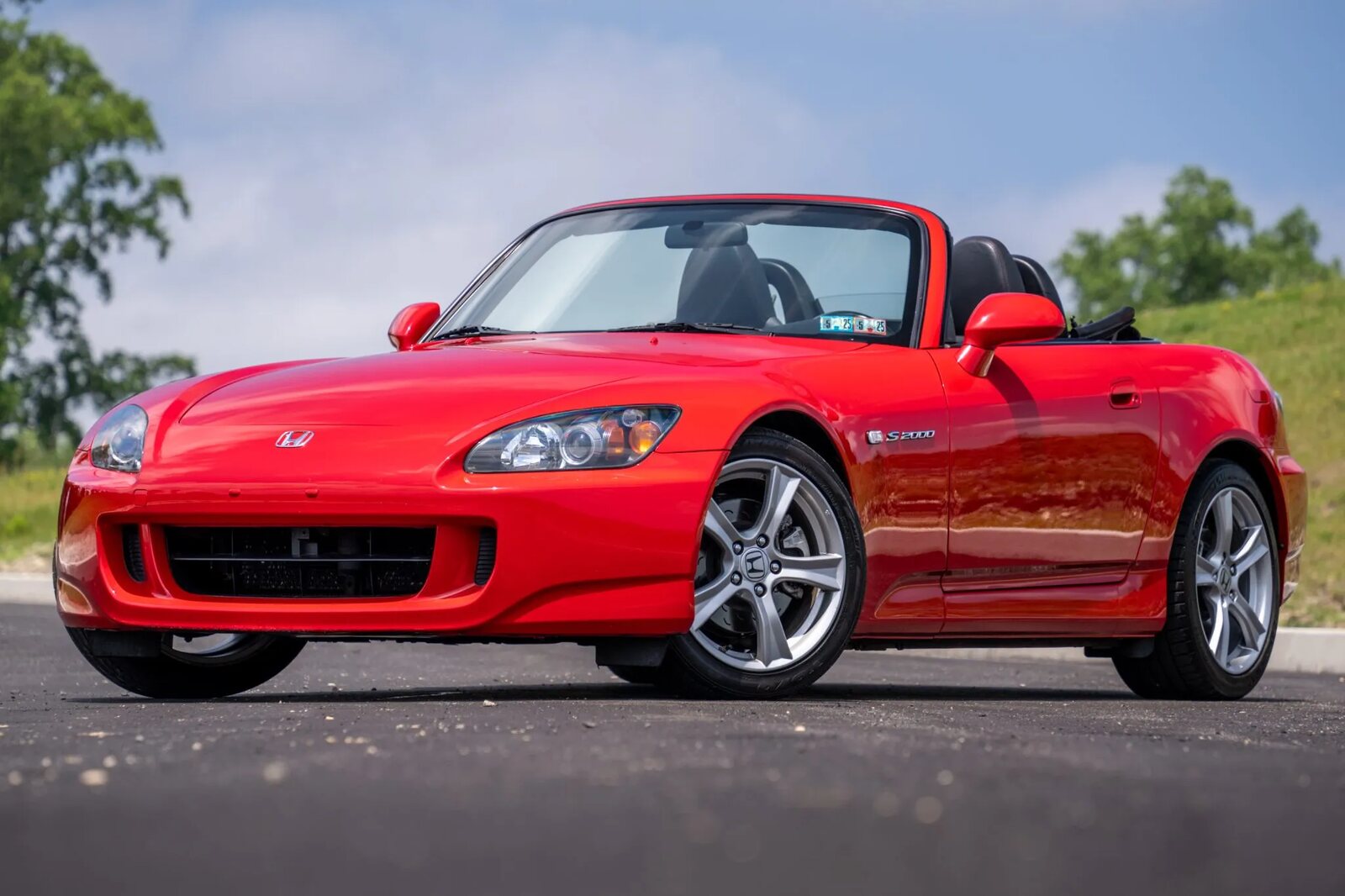 A red 2009 Honda S2000 parked in left angle view