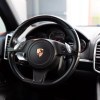The steering wheel in close view inside a 2014 Porsche Cayenne Diesel