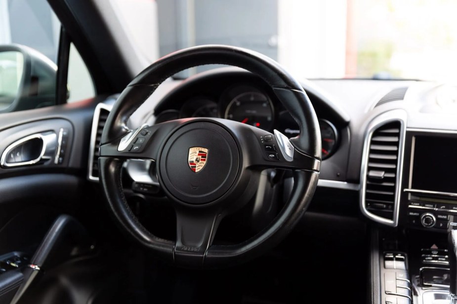The steering wheel in close view inside a 2014 Porsche Cayenne Diesel