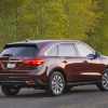 A red 2016 Acura MDX parked in right rear angle view