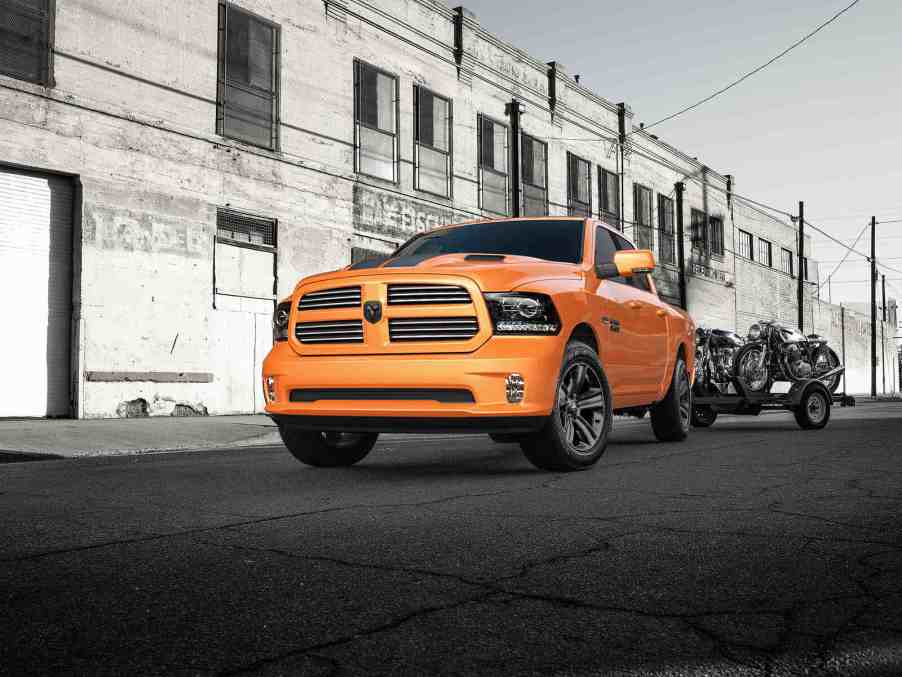 A 2017 Ram 1500 Sport in special edition "Ignition Orange" parked in far low left front angle view