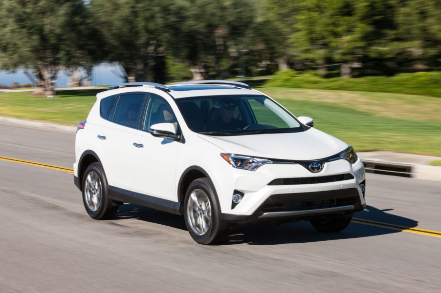A white 2017 Toyota RAV4 driving in right front angle view