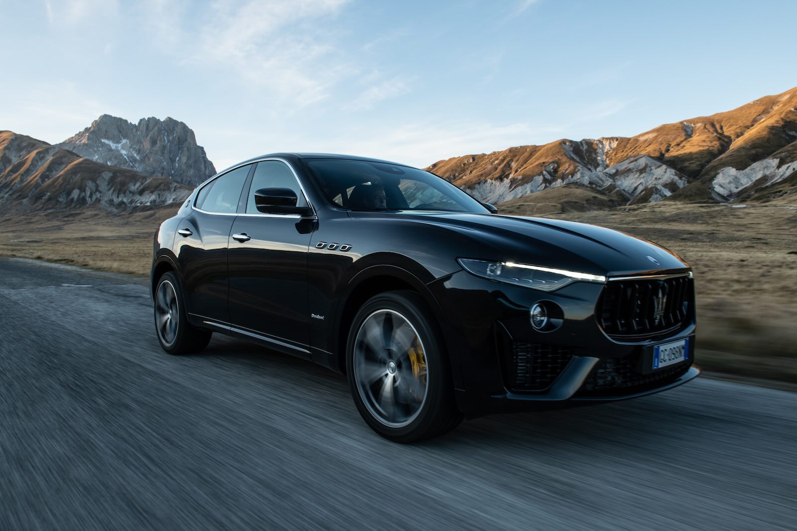 Maserati luxury crossover SUV with mountains visible in the background.