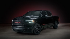A dark 2022 Ram 1500 parked in shadowy left front angle view