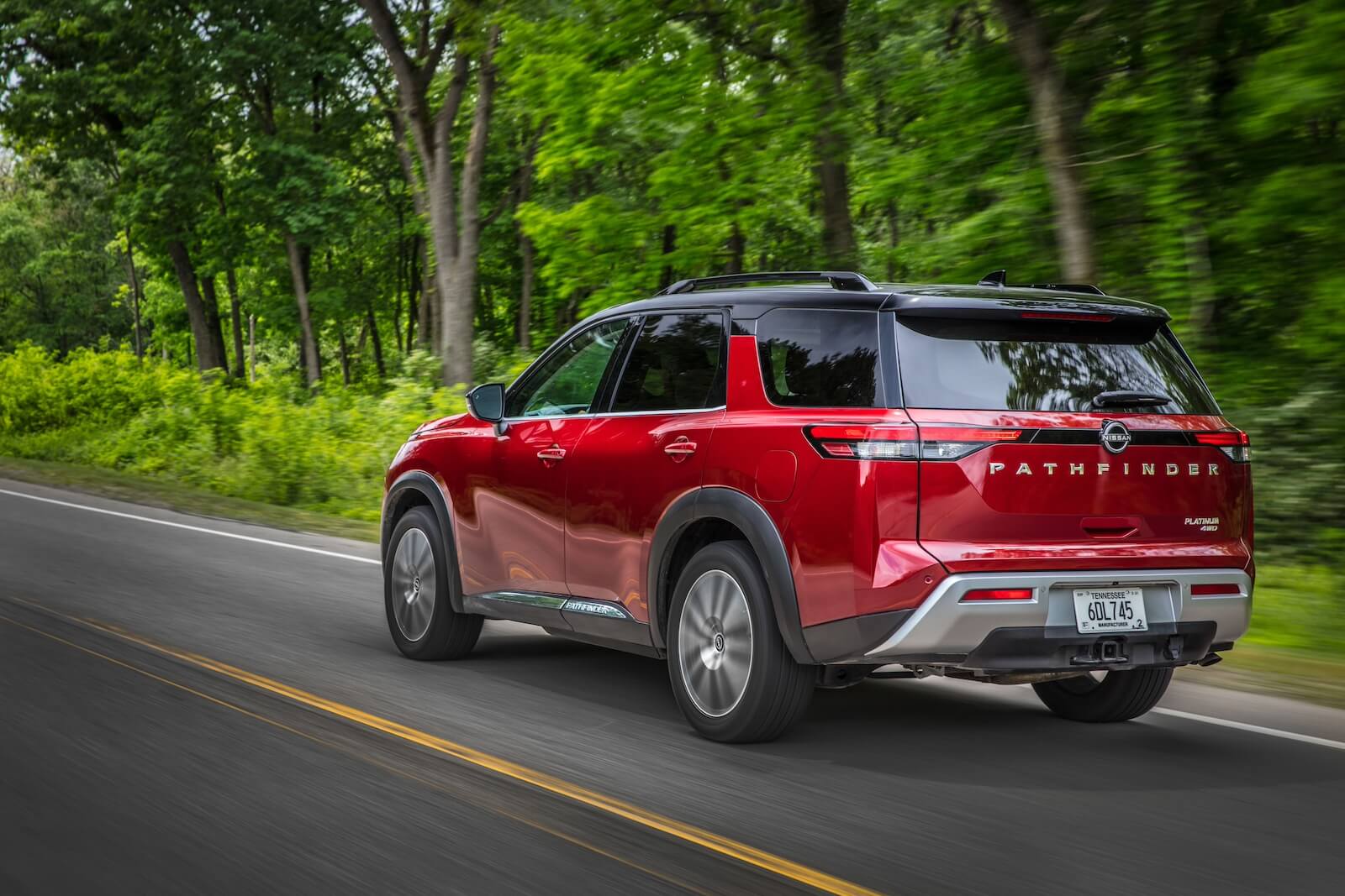 A 2023 Nissan Pathfinder driving down the road.