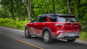 A 2023 Nissan Pathfinder driving down the road.