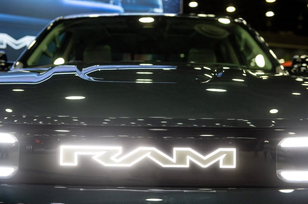 The illuminated RAM logo on a pickup truck grille.