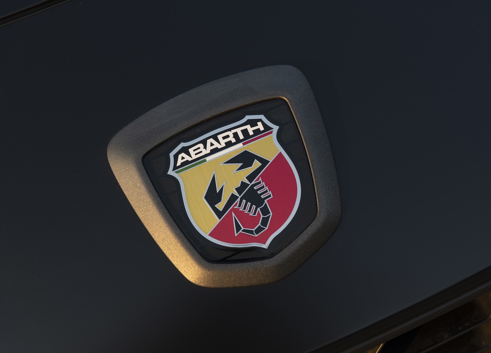 The Scorpio/Scorpion logo on the hood of a Fiat 124 Spider Abarth edition
