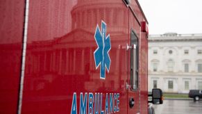 The side of a red ambulance vehicle.