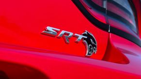A bright-red Dodge Charger SRT Hellcat shows off its badging.