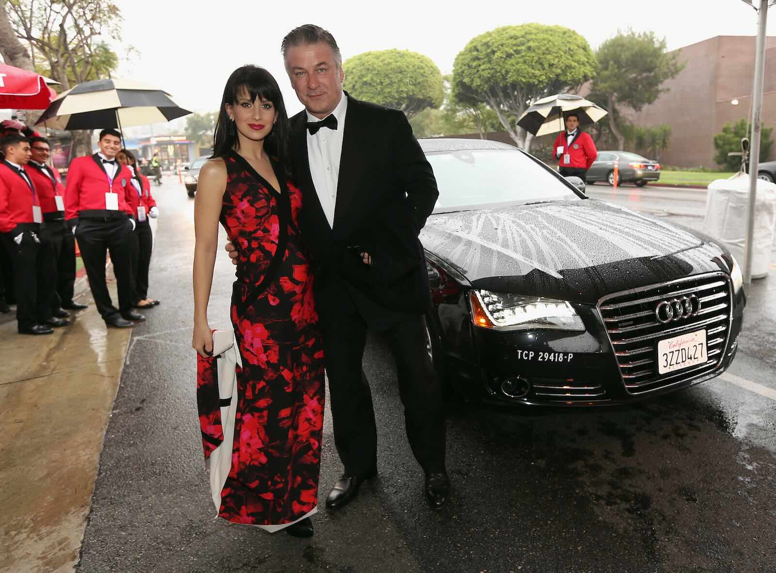 Actor Alec Baldwin stands in front of a black Audi A8 L limousine sedan