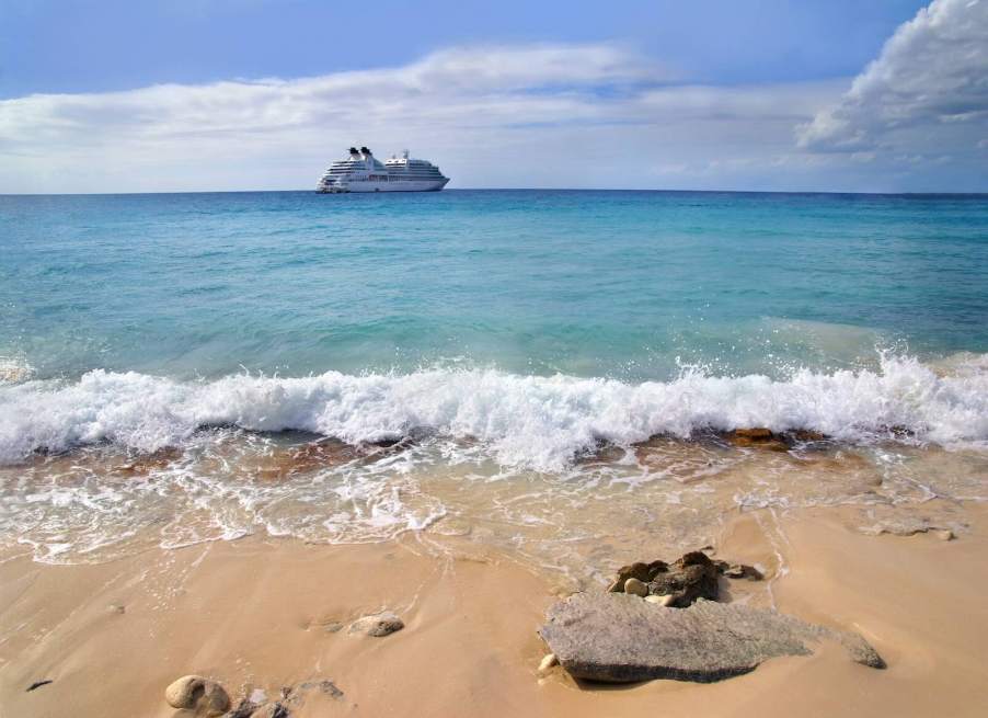 View of a cruise ship leaving an island from the beach.