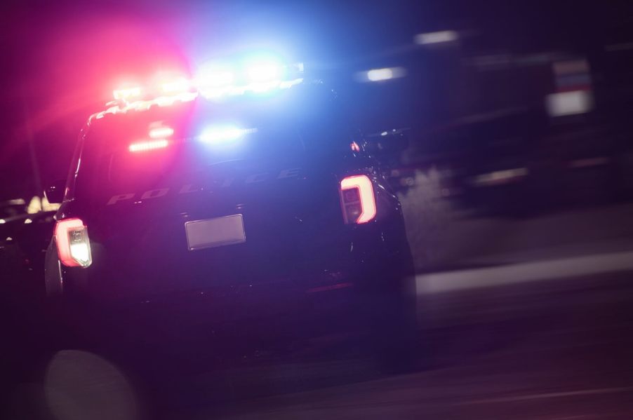 An image shows a police vehicle at a checkpoint cracking down on drunk driving.