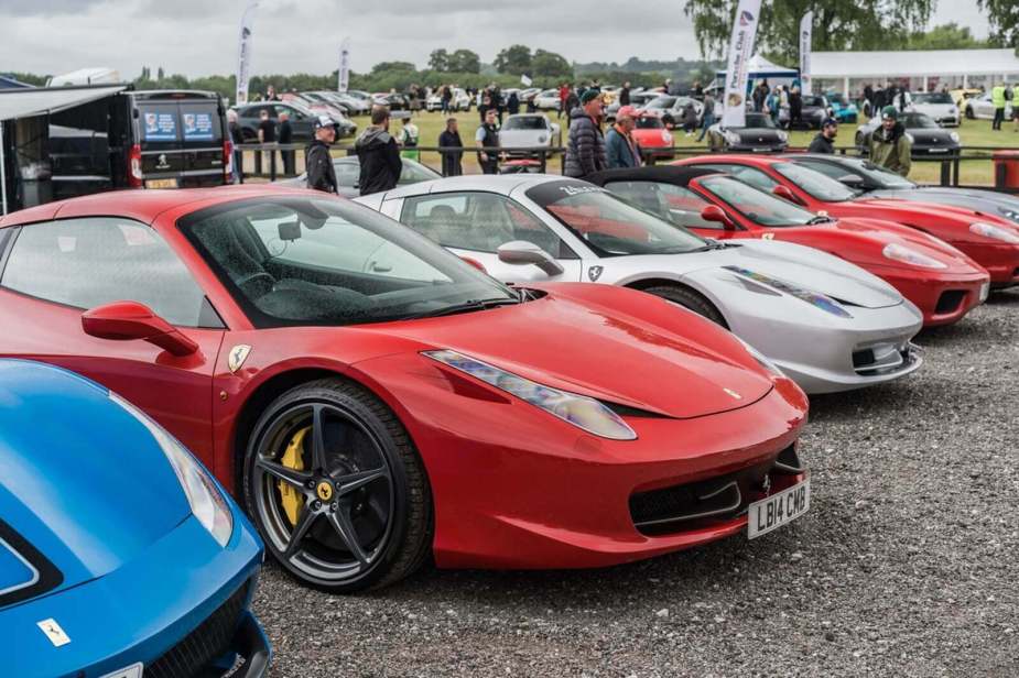 A lineup of Ferrari supercars at a show.