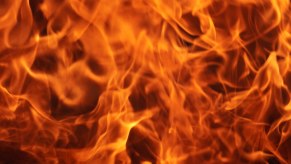 Gasoline fire closeup with orange flames on a black background