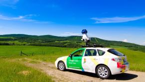 Google Street View camera car parked on a dirt pull-off, mountains visible in the distance.