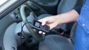 A mechanic scanning a car