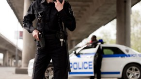 Ohio sheriff's deputies standing under a bridge to complete a traffic stop