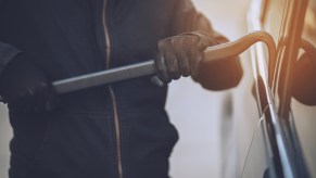 Pickup truck being stolen with a pry bar to get through the window seals and open the lock