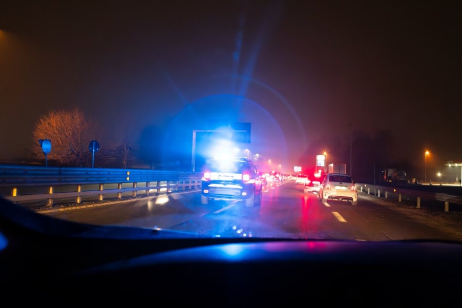 A police traffic stop on a busy highway.