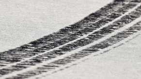 Skid marks from a supercar on a race track.