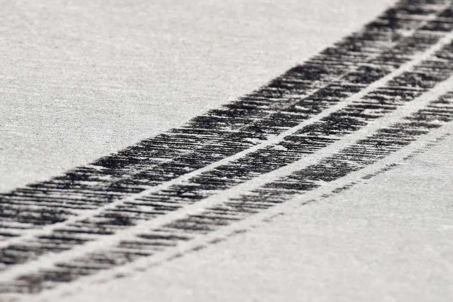 Skid marks from a supercar on a race track.