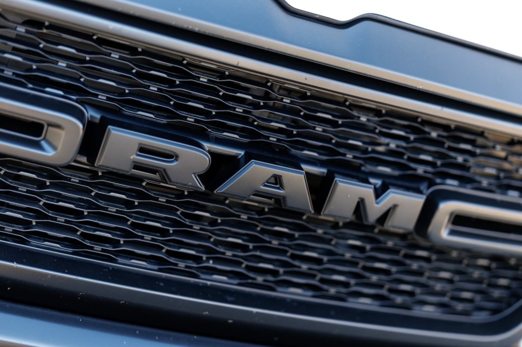 The Ram logo on the black grille of a full-size pickup truck