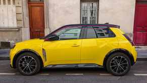 Bright yellow Renault 5 retro EV on the streets of Paris, where France is building a wireless charging road