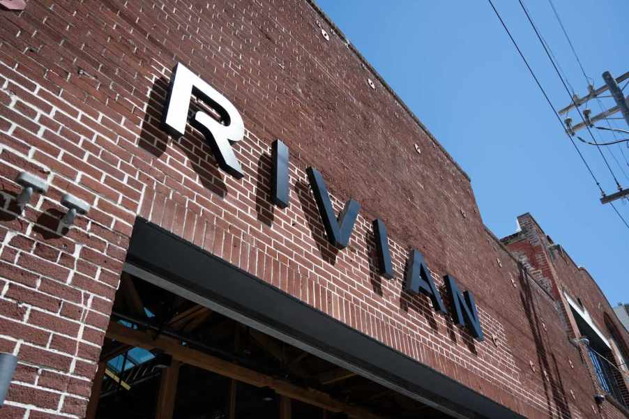 The Rivian logo on the side of a brick building
