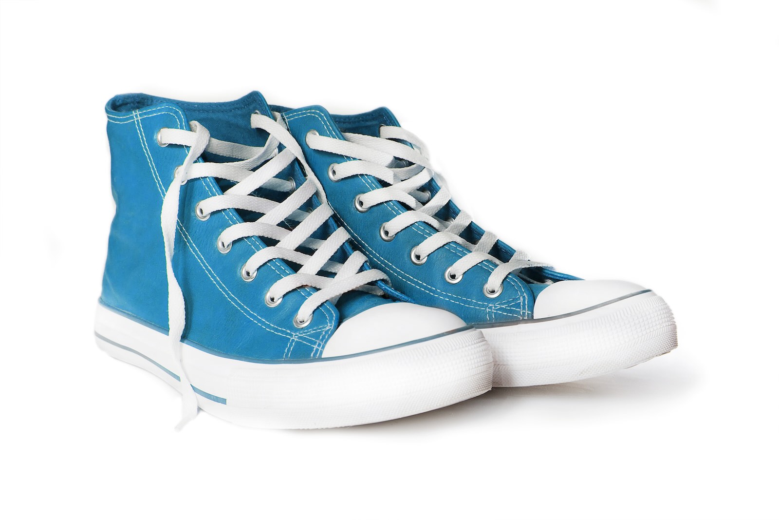 Turquoise converse sneakers on a white background.