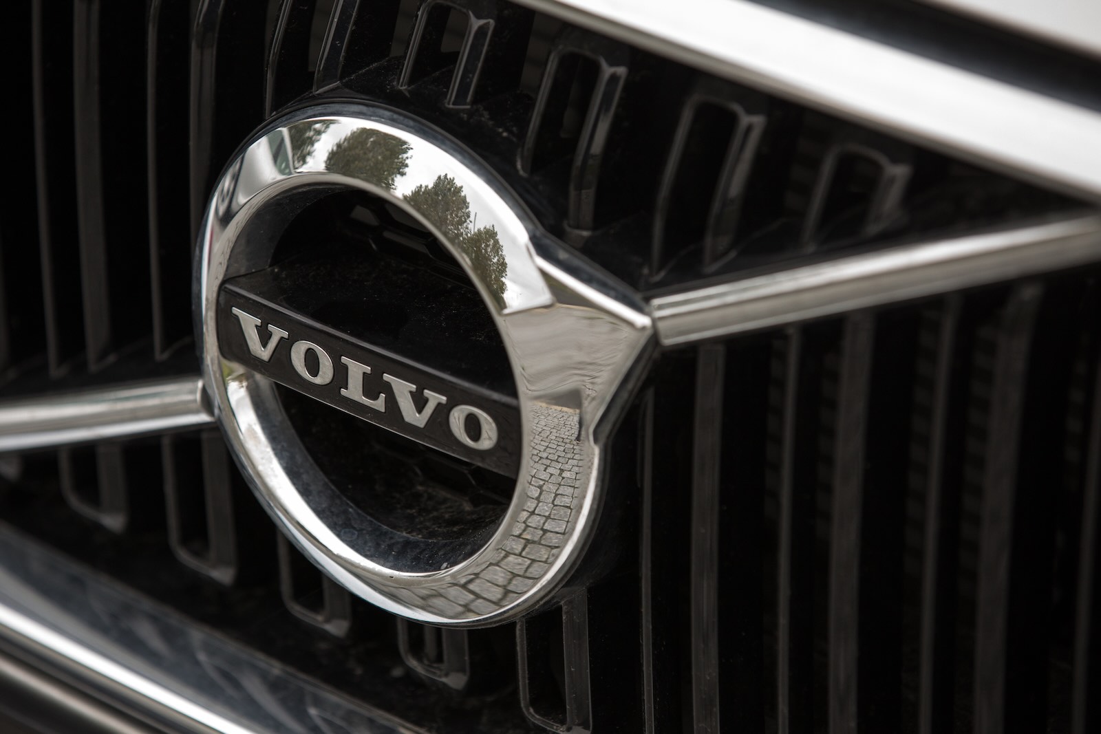 The chrome Volvo circle and arrow logo badge on a car's grille.