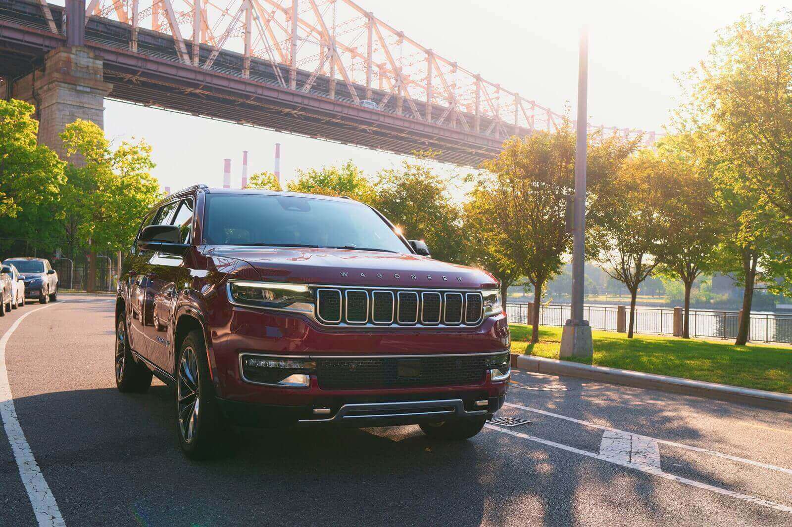 A Jeep Wagoneer driving on a city street. 