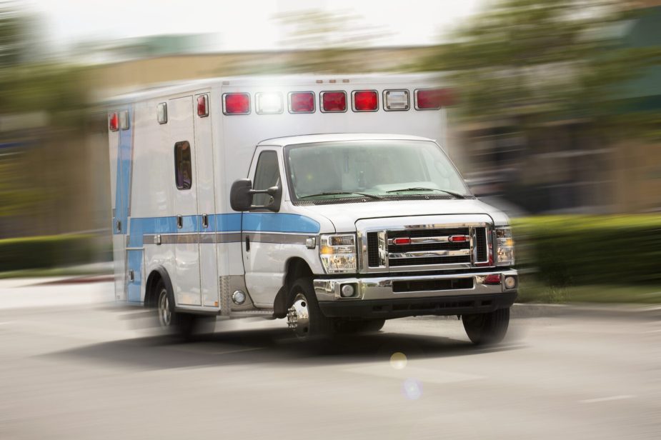 An ambulance driving in blurred right front view