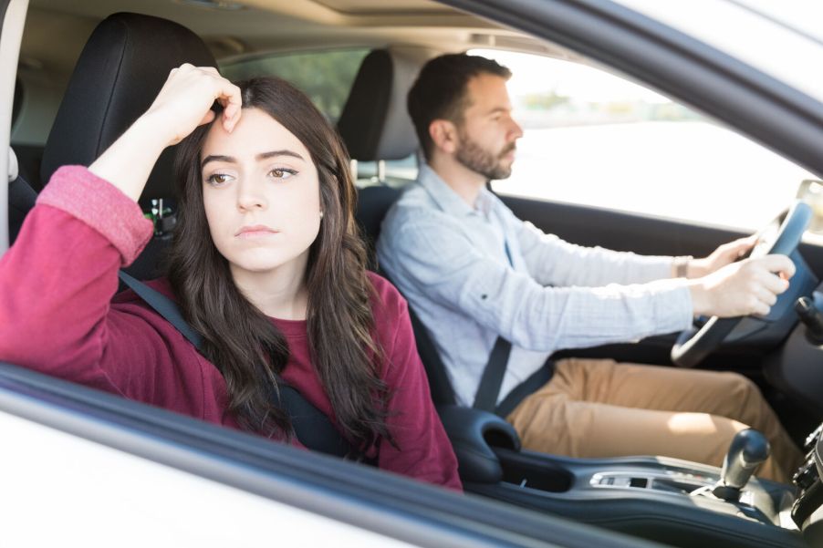 A couple driving in close cabin view