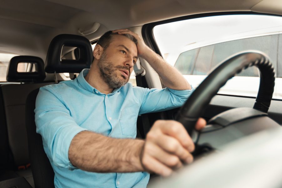A male driver waiting in traffic frustrated look
