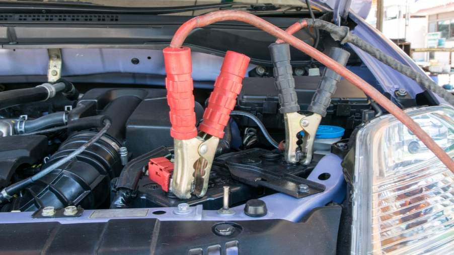 Jumper cables attached to car battery in close view
