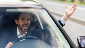 Angry male driver depicting road rage