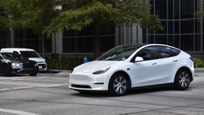 A white Tesla EV driving into an intersection in Texas