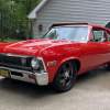 A red 1972 Chevrolet Nova parked in low left front angle view