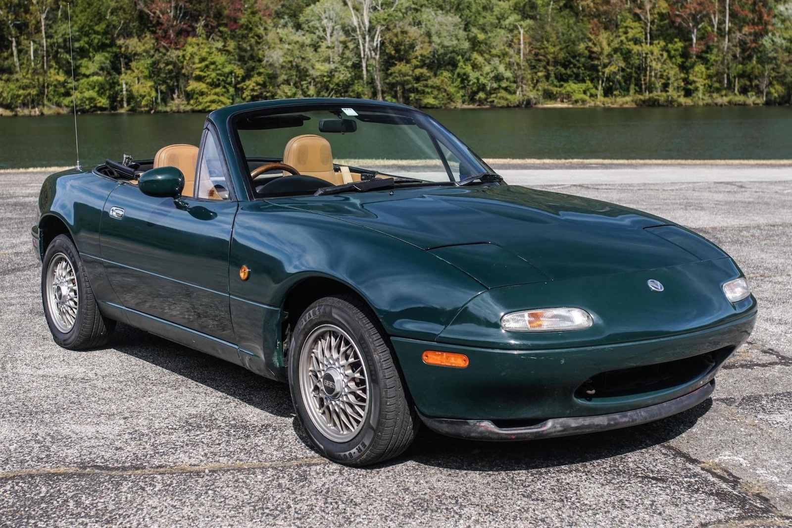 Dark green Eunos Roadster, a lake visible in the background.
